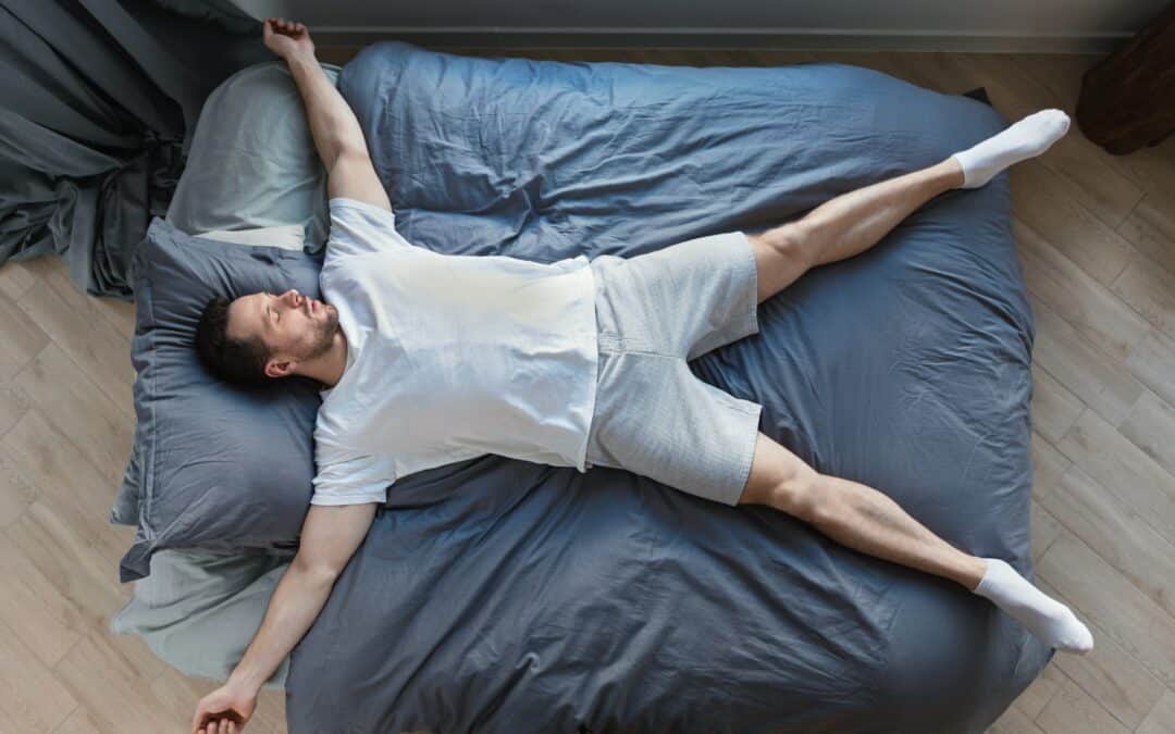 Man Sleeping Lying On Back In Bed At Home, Top-View